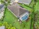 Aerial view of a single-Gathering home with a large backyard, screened-in pool, and mature landscaping at 631 Independence Path, The Villages, FL 32163