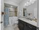 This bathroom offers a walk-in bathtub, modern vanity and sink, and neutral tiling at 631 Independence Path, The Villages, FL 32163