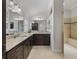 Bathroom with granite countertops, dark cabinetry, and ample counter space at 631 Independence Path, The Villages, FL 32163