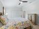 Cozy bedroom with soft carpet, ample storage, and a floral comforter at 631 Independence Path, The Villages, FL 32163