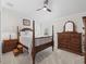 Bedroom with a four-poster bed, carpet, and traditional wood furniture at 631 Independence Path, The Villages, FL 32163