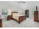Comfortable bedroom with neutral carpet, natural light, and a spacious walk-in closet at 631 Independence Path, The Villages, FL 32163