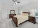 Bedroom featuring soft carpet, natural light, and traditional wood furniture at 631 Independence Path, The Villages, FL 32163