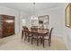 Formal dining room with a dark wood table set, complemented by tiled floors and elegant accents at 631 Independence Path, The Villages, FL 32163