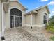 Close up of front door with decorative security screen and brick pavers at 631 Independence Path, The Villages, FL 32163