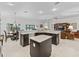 Bright kitchen features stainless steel appliances, granite countertops and dark cabinetry at 631 Independence Path, The Villages, FL 32163