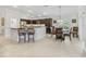 Well-appointed kitchen with dark cabinetry, stainless appliances, and a breakfast bar adjacent to the dining area at 631 Independence Path, The Villages, FL 32163