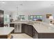 Bright kitchen features granite countertops, stainless steel appliances, and dark wood cabinets at 631 Independence Path, The Villages, FL 32163