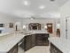 Open concept kitchen features granite countertops and stainless steel appliances at 631 Independence Path, The Villages, FL 32163