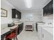 This laundry room offers great counter and cabinet space, with a sink and tile flooring at 631 Independence Path, The Villages, FL 32163