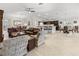 Open living room boasts comfortable seating and seamlessly integrates with the kitchen and dining areas at 631 Independence Path, The Villages, FL 32163
