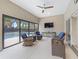 Enclosed sunroom features an outdoor seating area with view of the pool at 631 Independence Path, The Villages, FL 32163