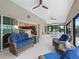 Bright sunroom features comfortable seating, ceiling fans, and sliding glass doors with outside views at 631 Independence Path, The Villages, FL 32163