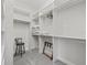 Spacious walk-in closet with custom shelving and plenty of storage space at 631 Independence Path, The Villages, FL 32163