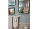 Charming bathroom with light blue walls, decorative mirrors, and fresh white towels at 66 Elmwood Trl, Deland, FL 32724