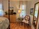 Comfortable bedroom with wood floors, a large dresser, and classic decor at 66 Elmwood Trl, Deland, FL 32724