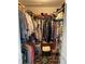 Walk-in closet with ample shelving, hanging racks and a stool for convenience at 66 Elmwood Trl, Deland, FL 32724
