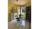 Bright breakfast nook with large windows, contemporary light fixture, and black furnishings at 66 Elmwood Trl, Deland, FL 32724
