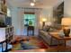 Cozy living room with a comfortable sofa, a colorful rug, and bright natural light at 66 Elmwood Trl, Deland, FL 32724