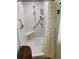 Clean shower area with a built-in seat, grab bar, and convenient storage shelves at 66 Elmwood Trl, Deland, FL 32724