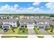 Aerial view of a neighborhood showcasing the manicured lawns and complementary home exteriors at 7627 Taormina Way, Clermont, FL 34714