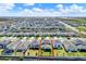 Beautiful aerial view of a home with a manicured lawn in a Gathering-friendly residential neighborhood at 7627 Taormina Way, Clermont, FL 34714