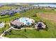 Aerial view of community pool, splash pad, and playground in a Gathering-friendly neighborhood, with manicured green space at 7627 Taormina Way, Clermont, FL 34714