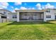 Large, grassy backyard featuring a screened-in porch that enhances outdoor living at 7627 Taormina Way, Clermont, FL 34714
