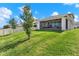 Well-maintained backyard featuring a partial view of the screened porch and exterior at 7627 Taormina Way, Clermont, FL 34714