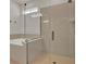 A modern bathroom with tub and glass enclosed shower featuring sleek fixtures and tile at 7627 Taormina Way, Clermont, FL 34714
