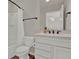 Bathroom with a white vanity, granite countertop, and shower with white curtain at 7627 Taormina Way, Clermont, FL 34714