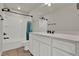 Bathroom featuring a shower-tub combo, dark fixtures, and white vanity at 7627 Taormina Way, Clermont, FL 34714