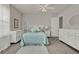 Bright bedroom with a queen bed, ceiling fan, and white furniture at 7627 Taormina Way, Clermont, FL 34714