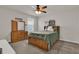 Bedroom with a wood bed frame, ceiling fan, and wooden dresser at 7627 Taormina Way, Clermont, FL 34714