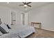 Cozy bedroom showcasing a plush bed, neutral walls and carpet, with doorways leading to a bathroom and hallway at 7627 Taormina Way, Clermont, FL 34714
