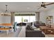Open floor plan including dining area with modern chandelier and sliding door access to the screened porch at 7627 Taormina Way, Clermont, FL 34714