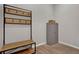 Practical entryway featuring a bench and coat rack, offering convenient storage solutions at 7627 Taormina Way, Clermont, FL 34714