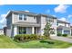 Charming two-story home with neutral siding, well-manicured lawn, and a welcoming front porch at 7627 Taormina Way, Clermont, FL 34714