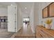 Hallway with hardwood floors leading to the living room with natural light at 7627 Taormina Way, Clermont, FL 34714