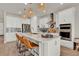 Modern kitchen with white cabinets, stainless steel appliances, and island with barstool seating at 7627 Taormina Way, Clermont, FL 34714