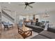 Open floor plan featuring spacious living room with staircase, kitchen with bar seating, and dining area at 7627 Taormina Way, Clermont, FL 34714