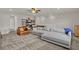 Spacious living room with large sectional sofa, leather chair, and shelving unit providing style and function at 7627 Taormina Way, Clermont, FL 34714