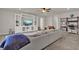 Open living space featuring a sectional sofa, built in cabinets and shelving, and adjacent desk space at 7627 Taormina Way, Clermont, FL 34714