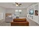Open living space showcasing a large sectional, built-in shelving and entertainment center, and cozy leather armchair at 7627 Taormina Way, Clermont, FL 34714