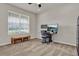Office space with a window, desk with dual monitors, and a wooden bench at 7627 Taormina Way, Clermont, FL 34714
