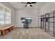 Office space with desk, shelving unit, bench, and natural light at 7627 Taormina Way, Clermont, FL 34714