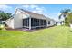 Well-maintained backyard featuring a screened-in lanai and lush lawn at 815 Cortez Ave, Lady Lake, FL 32159