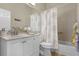 Bathroom with vanity and sink with decorative seashell curtain and tile at 815 Cortez Ave, Lady Lake, FL 32159