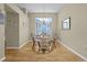 Cozy dining room with wood floors and plenty of natural light from a large window at 815 Cortez Ave, Lady Lake, FL 32159