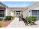 Close up view of the home's entryway with beautiful pavers and landscaping at 815 Cortez Ave, Lady Lake, FL 32159